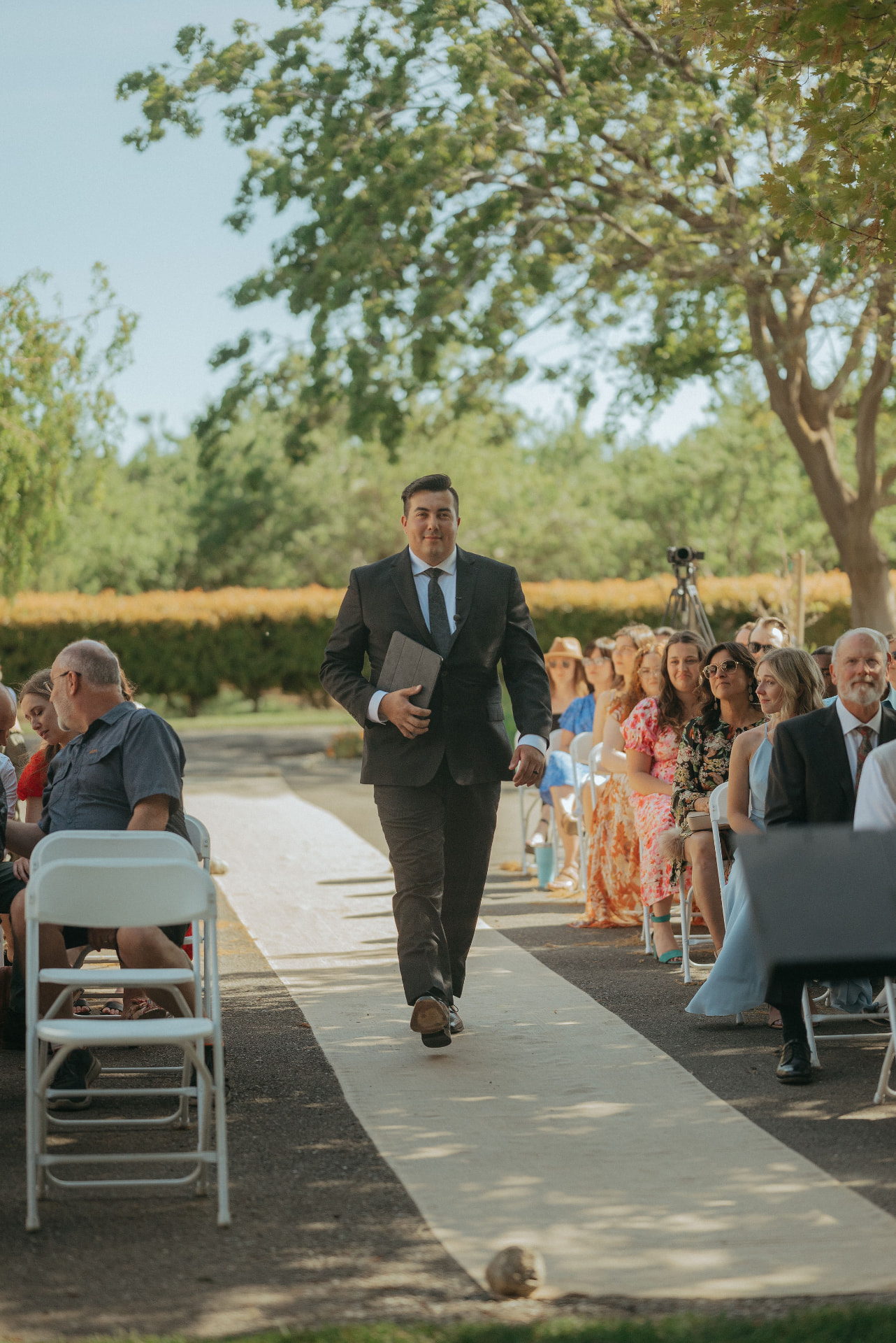 Alec Russo walking down a wedding aisle, ready to officiate